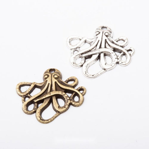 Assorted antique bronze and antique silver textured octopus charm pieces on white