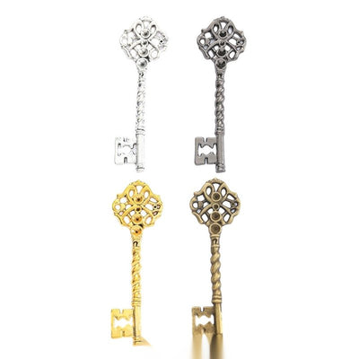Ornate key charm shown across the available finishes