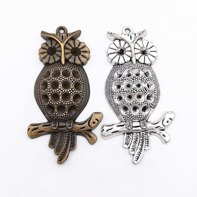 Group view of pineapple-body owl charm showing all 2 pictured finish variants