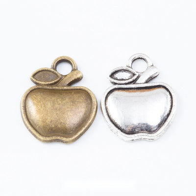 apple shaped round cabochon bezel charms in two finishes shown together in the available finishes