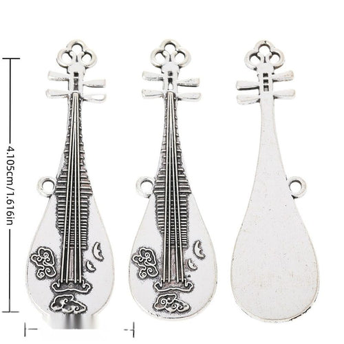 Long pipa lute charm with engraved strings and floral decoration shown in arranged finish comparison