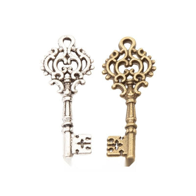 Filigree Key Charm grouped finish options on a white background