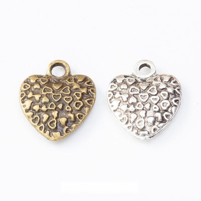 Puffed heart covered with tiny raised heart motifs shown in the available finishes