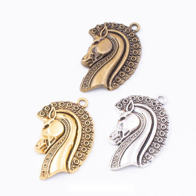 Decorative Horse Head Metal Charms in Three Finishes in multiple metallic finishes displayed together on a white backgro