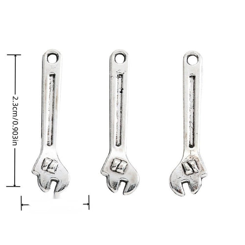 Front-facing arrangement of adjustable wrench charms on a white background