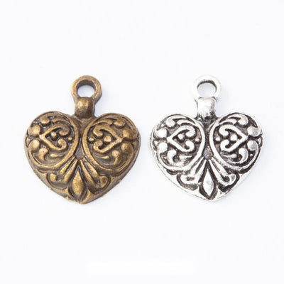 Filigree heart charm shown across the available finishes