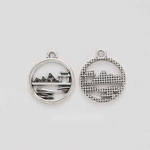 Round Landscape House Charm shown in all pictured finishes on a white background