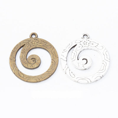 spiral wave round metal charms in two antique finishes shown together in the available finishes