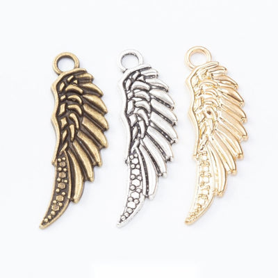 Curved Feathered Wing metal pieces shown in the available finishes.