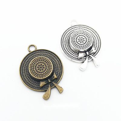 Front and finish comparison of round hat and bow charm