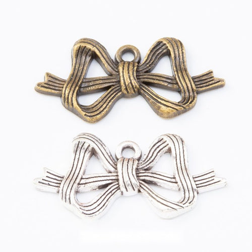 Layered Bow-Shaped Metal Charm Pendants shown in a grouped front view on a plain background