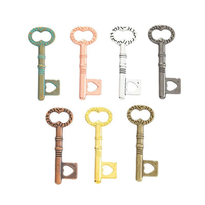 Grouped front views of the heart bow skeleton key charm in seven metallic finishes