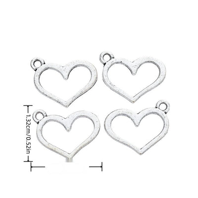 Simple open heart outline charm with a small top loop shown in arranged finish comparison