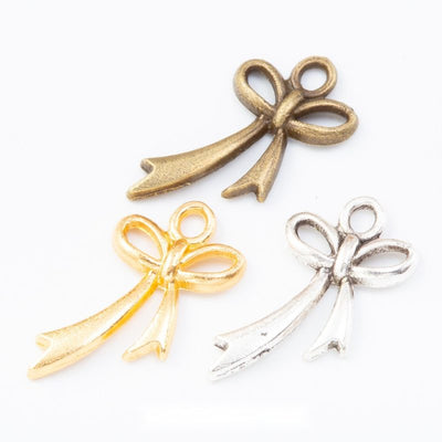 Ribbon Bow Charm grouped finish options on a white background