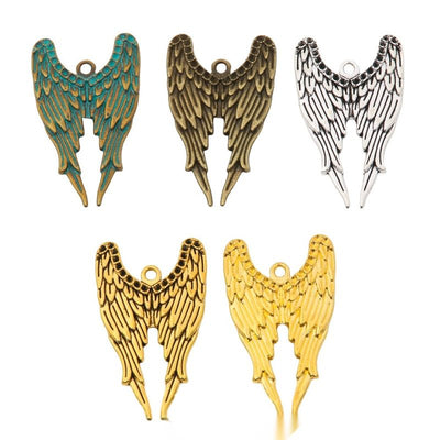 Grouped front view of double wing charm showing layered feather lines and a centered top loop