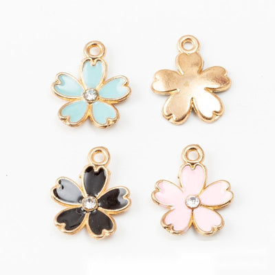 Grouped front view of crystal accent flower charms in the available finishes