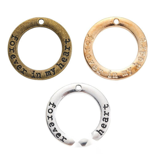 forever in my heart round message charm shown from the front in the available metallic finishes