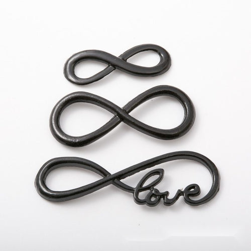 Assorted infinity link connectors arranged together on a white background