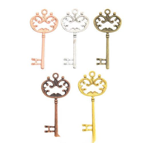 Group view of the ornate key charm showing the available finishes and front details