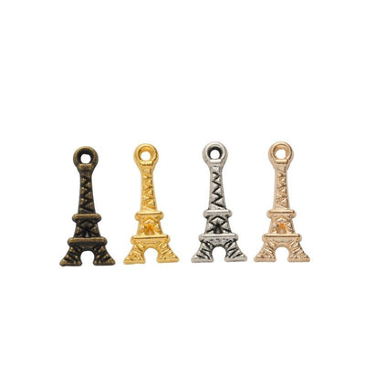Assorted Eiffel Tower charms arranged together on a white background