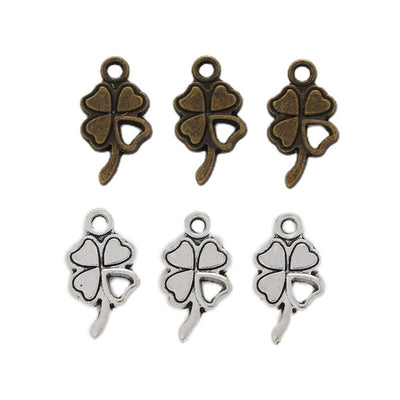 Grouped front view of four leaf clover charms in the available finishes