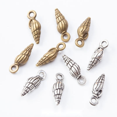 Elongated spiral shell charms with deeply ridged surfaces arranged together on a white background.