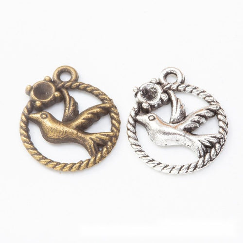 Group view of round bird charm showing all 2 pictured finish variants