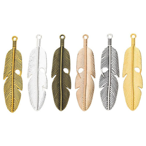 Assorted long feather charm pendants displayed together on a white background