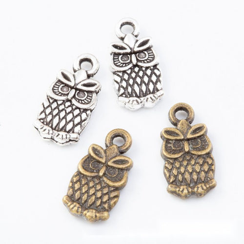 Group view of small bow owl charm on a white background