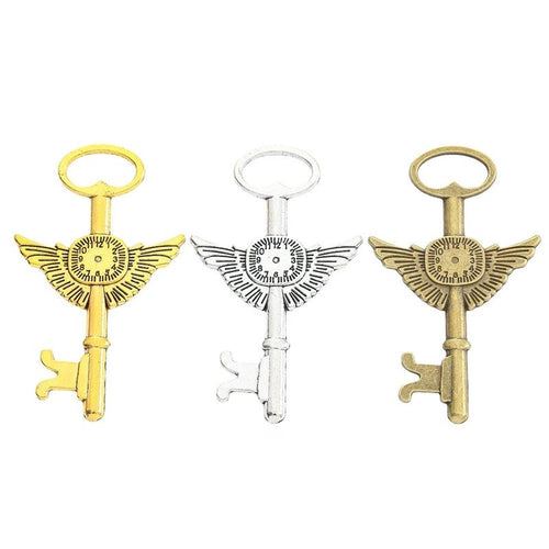 Winged Gear Skeleton Key Keychains in Three Finishes in multiple metallic finishes displayed together on a white backgro