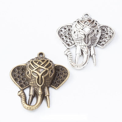Group view of the elephant head charm showing the available finishes and front details