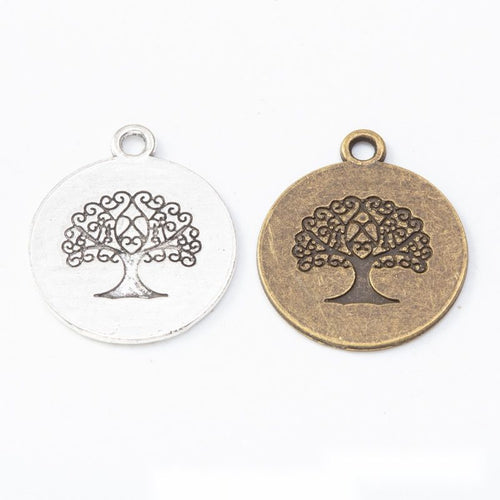 Front comparison of round tree of life medallion metal component in 2 finishes