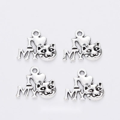 Grouped front views of the cat and my word cutout charm in available finishes