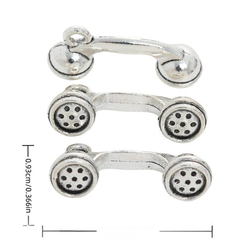 Front and reverse views of telephone receiver charms with measurement and weight guides