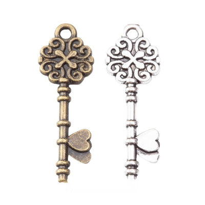 Floral Skeleton Key Charm finish comparison on a white background