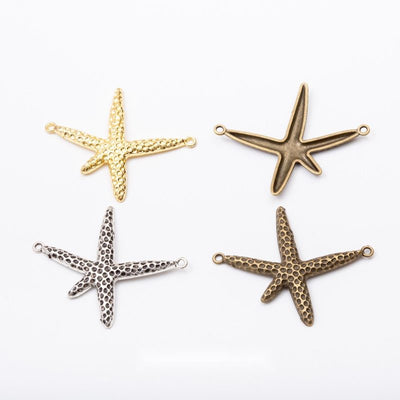 Textured Starfish Connector Charms in Three Finishes in multiple metallic finishes displayed together on a white backgro