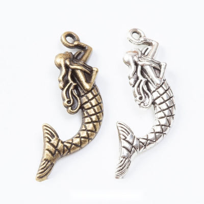 Group view of the mermaid charm showing the available finishes and front details