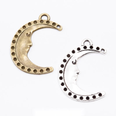 Group view of crescent moon with dotted edging and loops at both tips