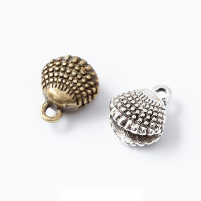 Grouped front views of textured shell charms