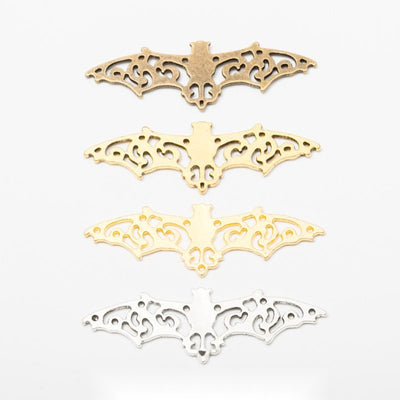 Assorted filigree bat wing connectors displayed together on a white background