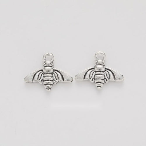 Grouped front views of the small bee charm in available finishes