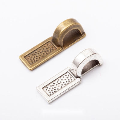 Rectangular dotted glue pad beneath a wide folded bail shown in the available finishes