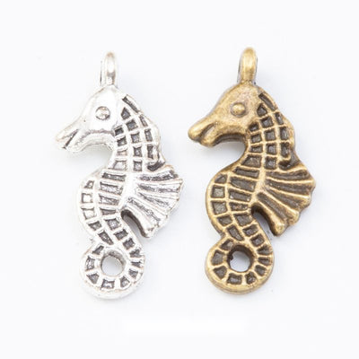 Group view of the seahorse charm showing the available finishes and front details