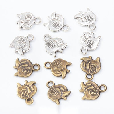 Group view of the tiny elephant charm showing the available finishes and front details