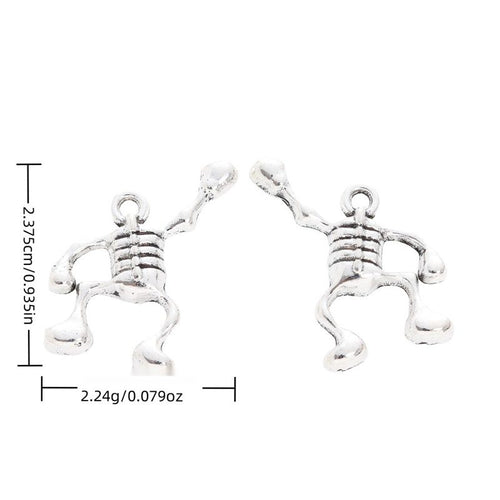 Metal articulated skeleton charm, front and reverse views shown in the product image