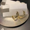Twisted Metal Hoop Earring Collection with Sculpted Polished Metal Details view 4