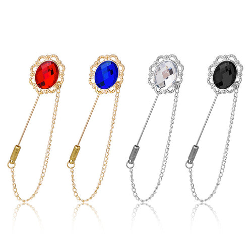 Four crystal stick pin brooches in red blue clear and black on white