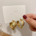 Twisted Ridged Hoop Earrings with Sculpted Polished Metal Details view 3