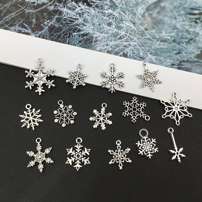 Black snowflake beads arranged on a light background