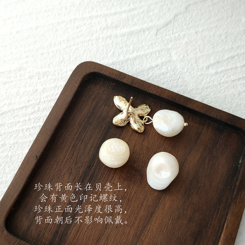 Butterfly pearl earring back and pearl reverses on wood tray